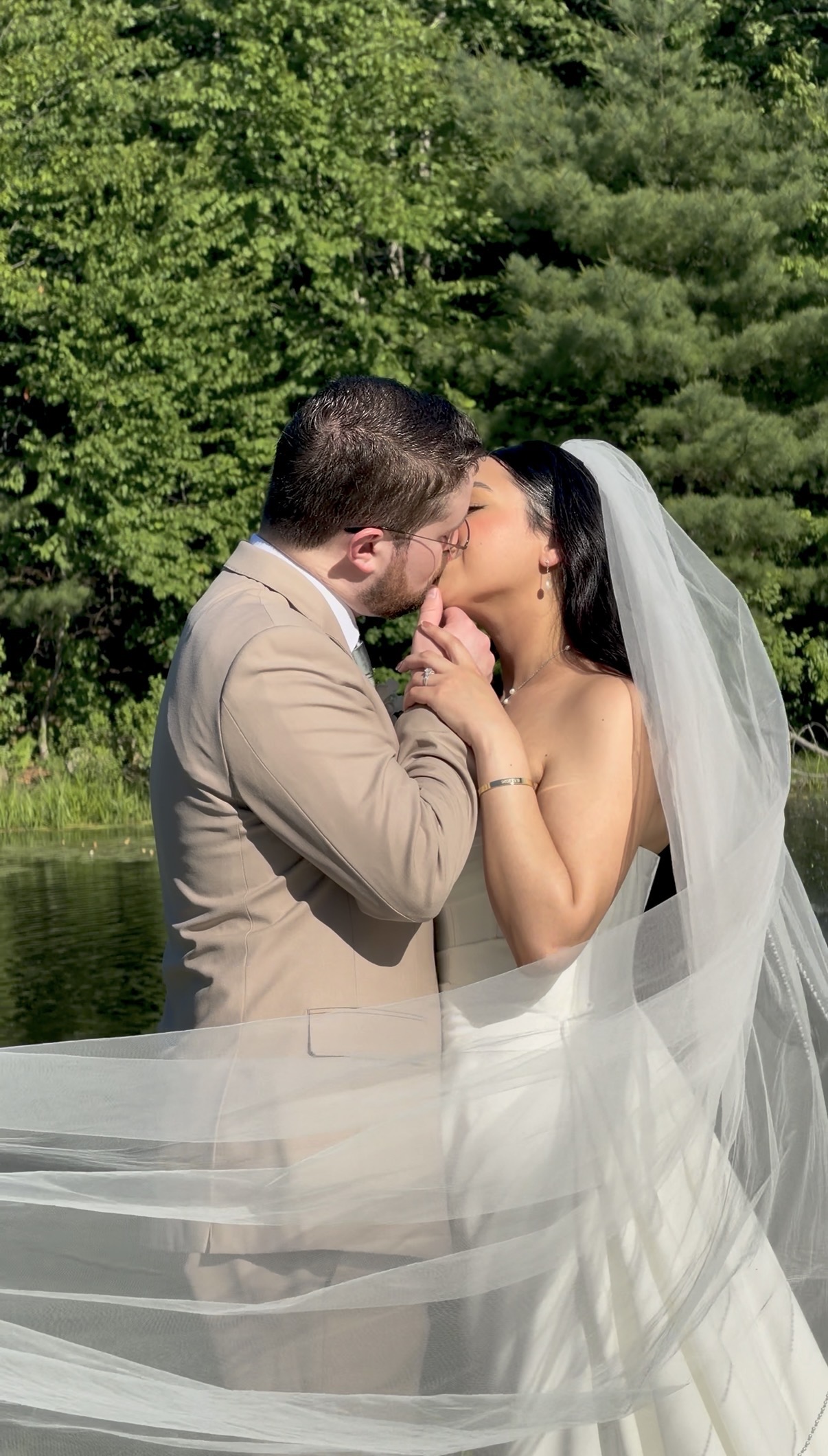 First kiss under the pavilion at a vineyard pavilion wedding at Zorvino Vineyards, Sandown NH