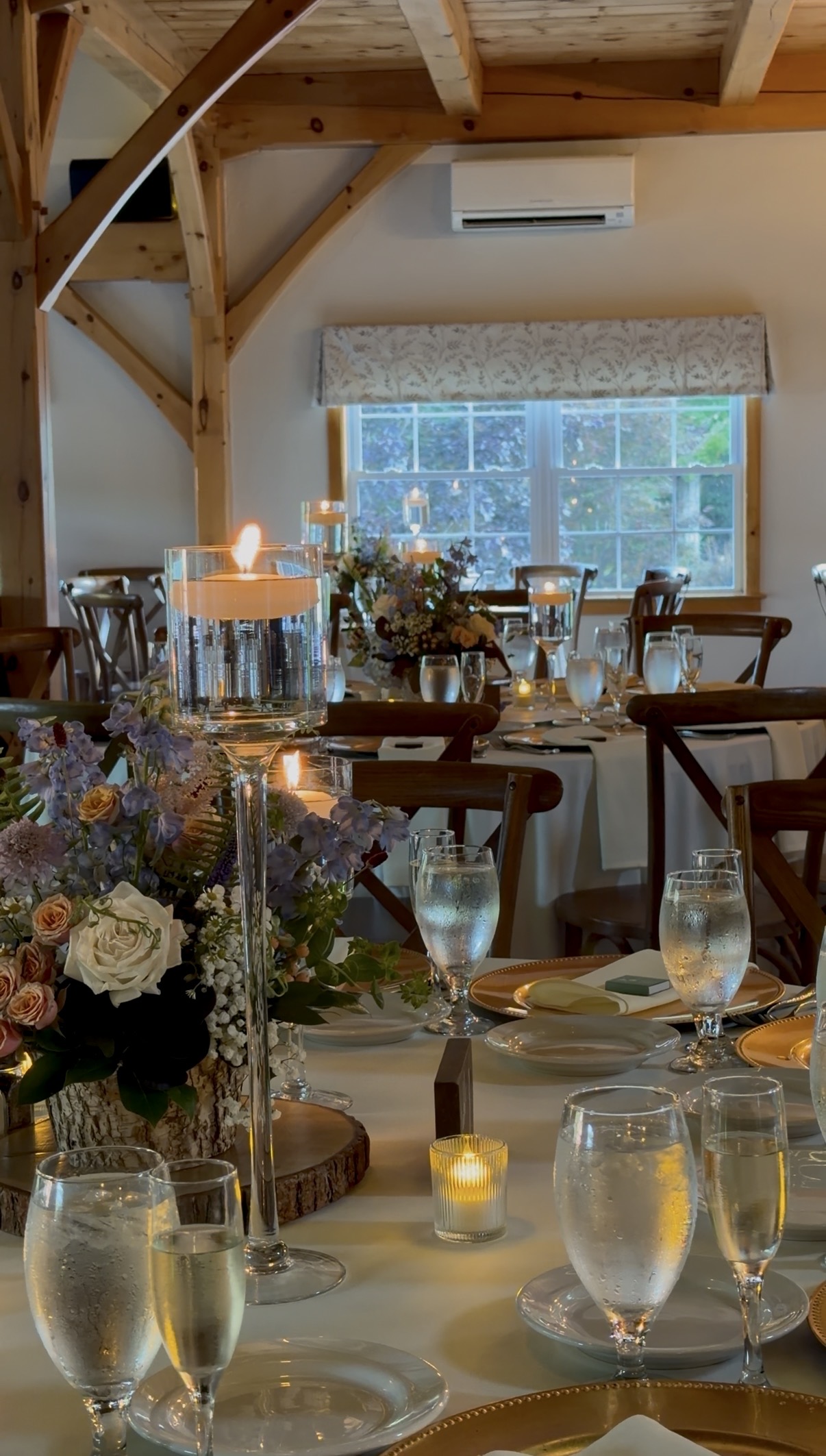 Decorated dinner tables with flowers and candles.