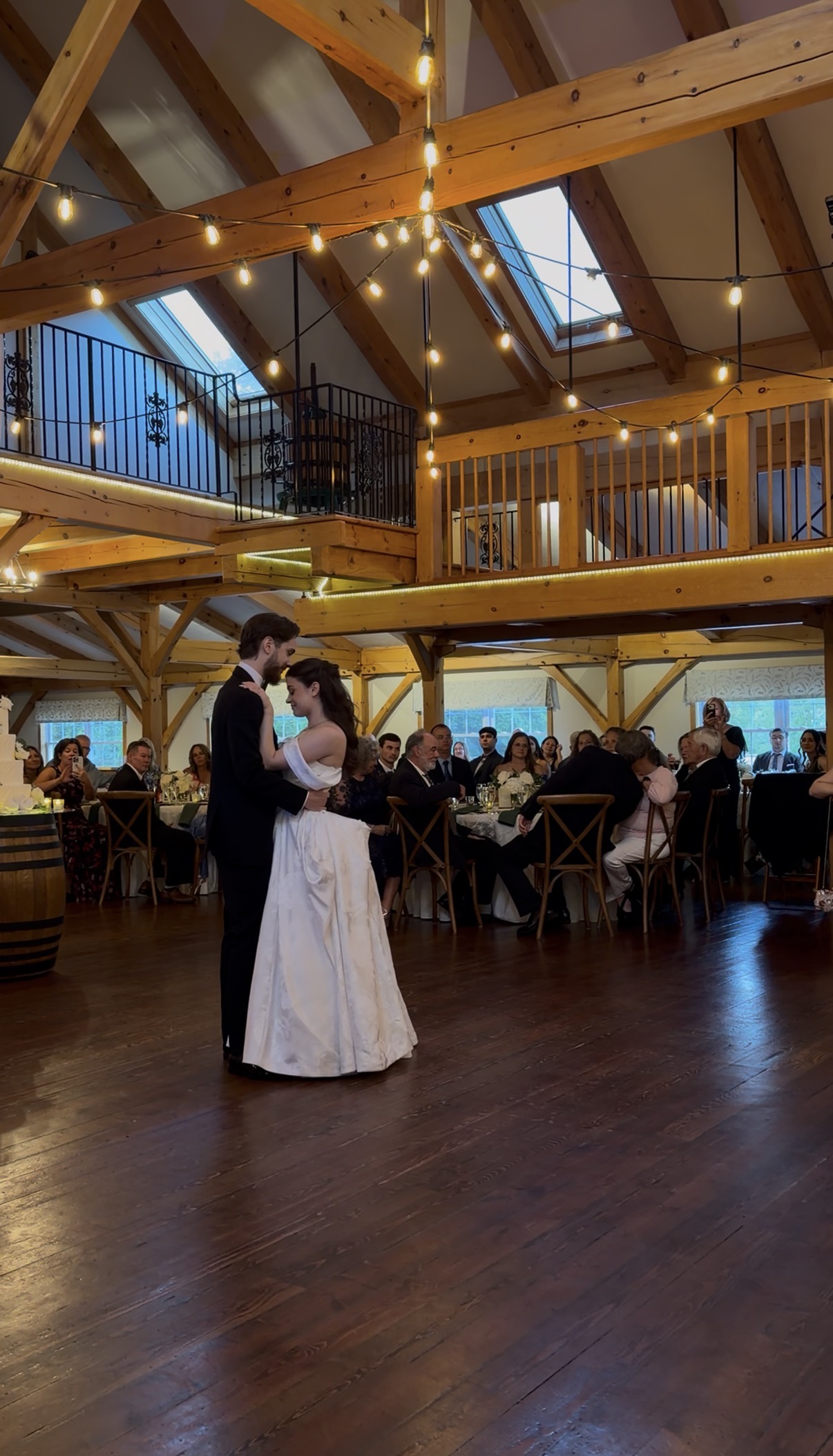 Bride and groom have their first dance in front of their guests.