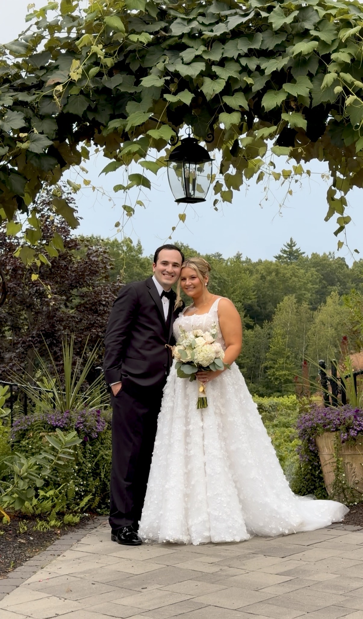 Bride and groom Beneath the grape arbor and its iron lantern, one of the spots our summer couples always find their way to.