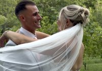 "Kaleigh Whitnell and Dante Abruzzese embracing beneath her veil at Zorvino Vineyards — Sunday summer wedding August 2026 Sandown NH"