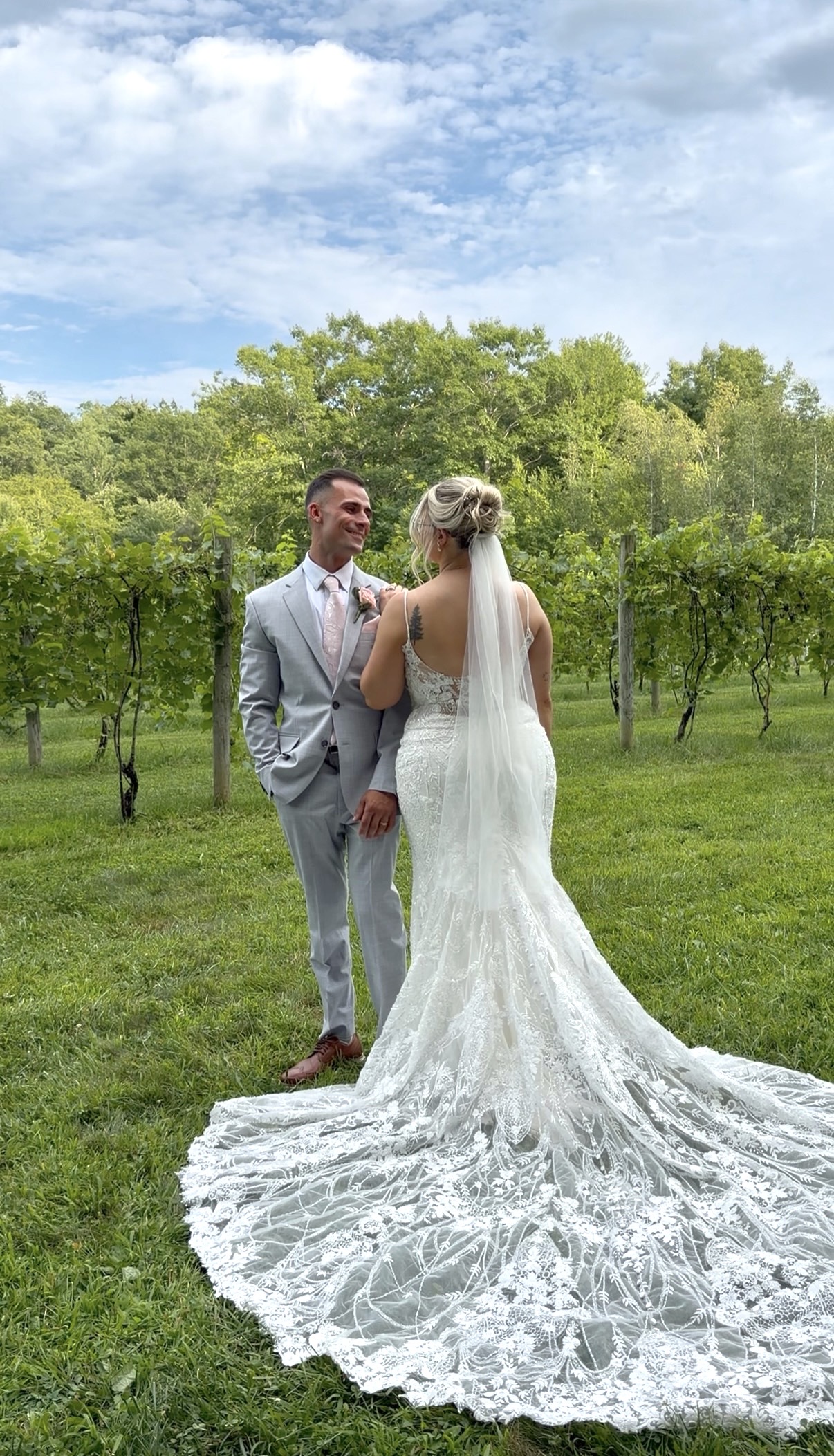 Bride and groom standing among the vineyard rows before the ceremony at Zorvino Vineyards