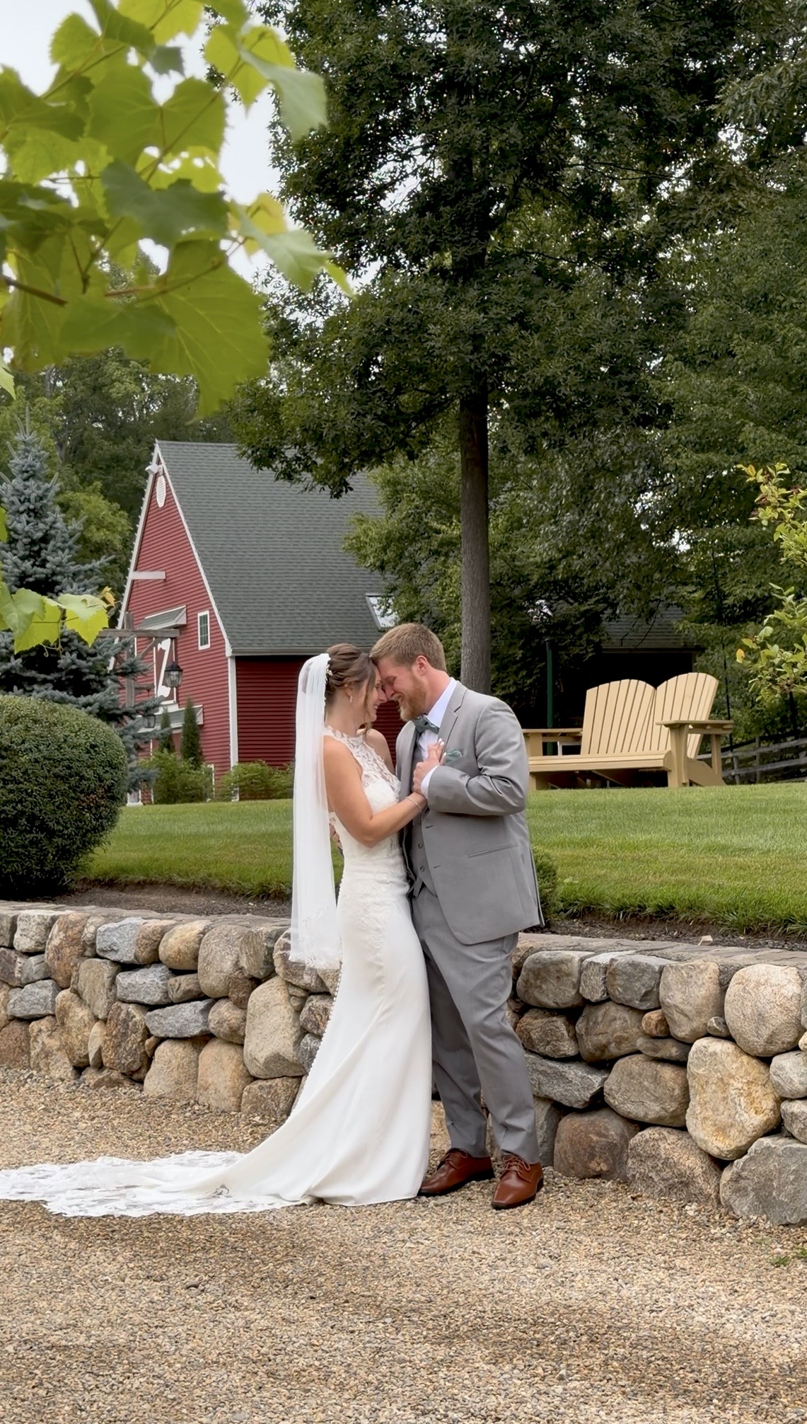 A tender moment on the estate grounds after the first look, the red barn behind them | Photography: @solarephotos