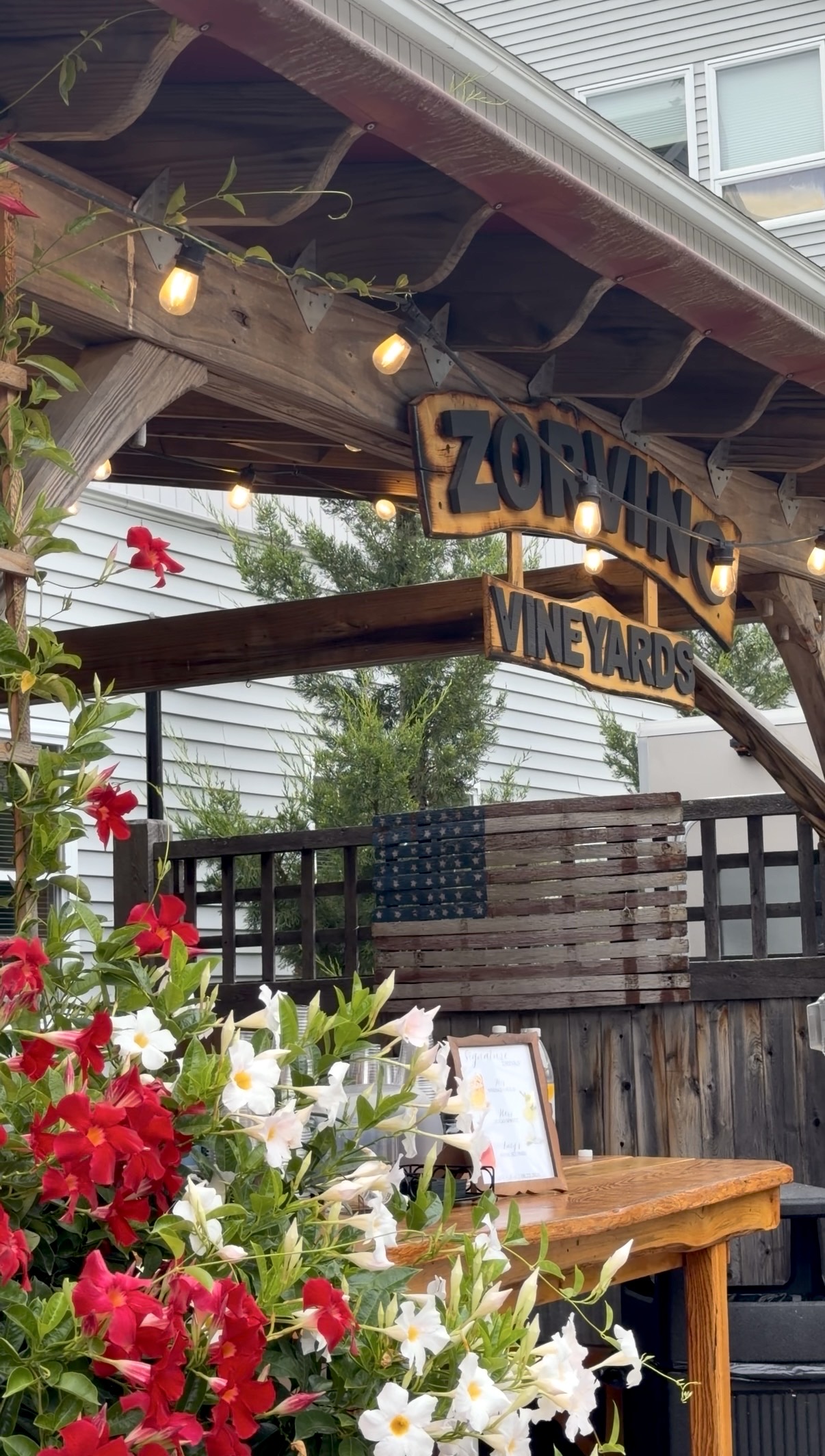The Zorvino patio, dressed in summer blooms and string lights | Photography: @solarephotos
