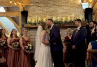 Mauve and navy vineyard wedding at Zorvino Vineyards: Meghan McDonnell and Alex Ventresca share their first kiss at the candlelit fireplace beneath a Mr. and Mrs. Ventresca monogram.