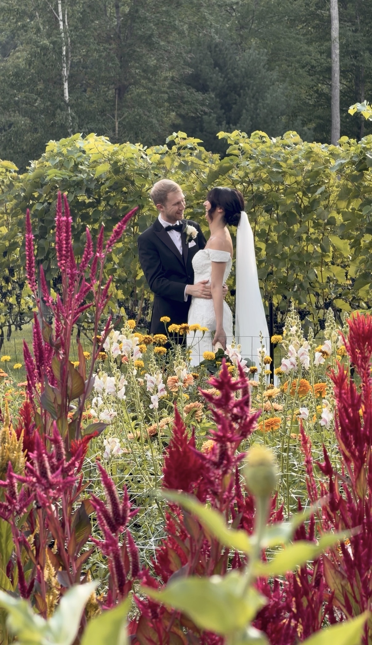 Groom makes bride laugh among wildflowers
