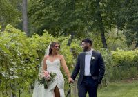 "Annie and Jake holding hands among the vineyard rows at Zorvino Vineyards — a dreamy summer vineyard wedding in Sandown NH, August 2026"