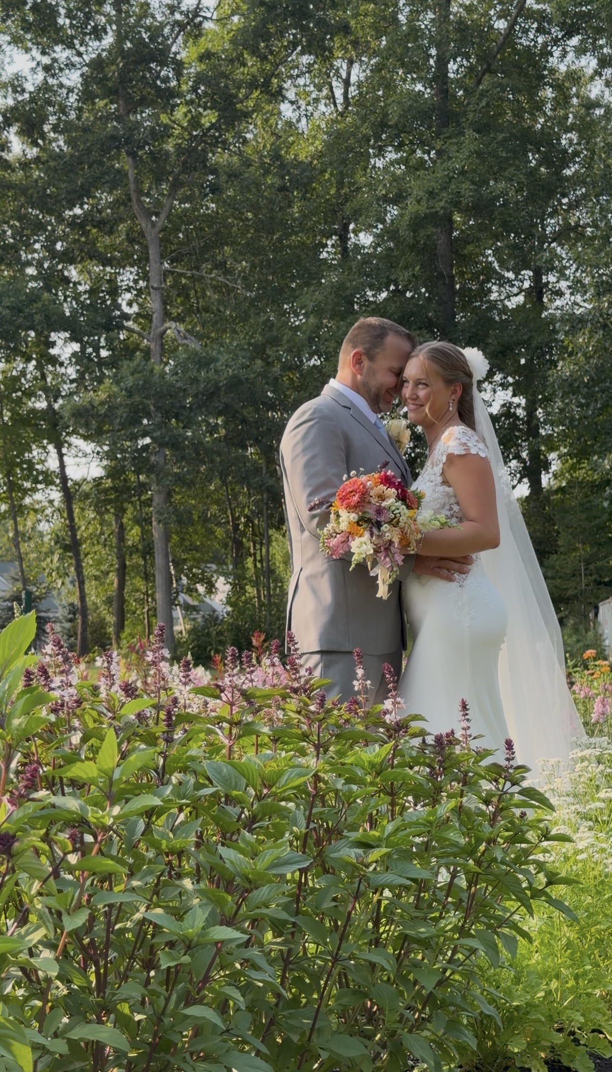 Bride and groom sharing a quiet moment among the garden blooms at their family vineyard wedding at Zorvino Vineyards A quiet minute among the late-summer blooms.