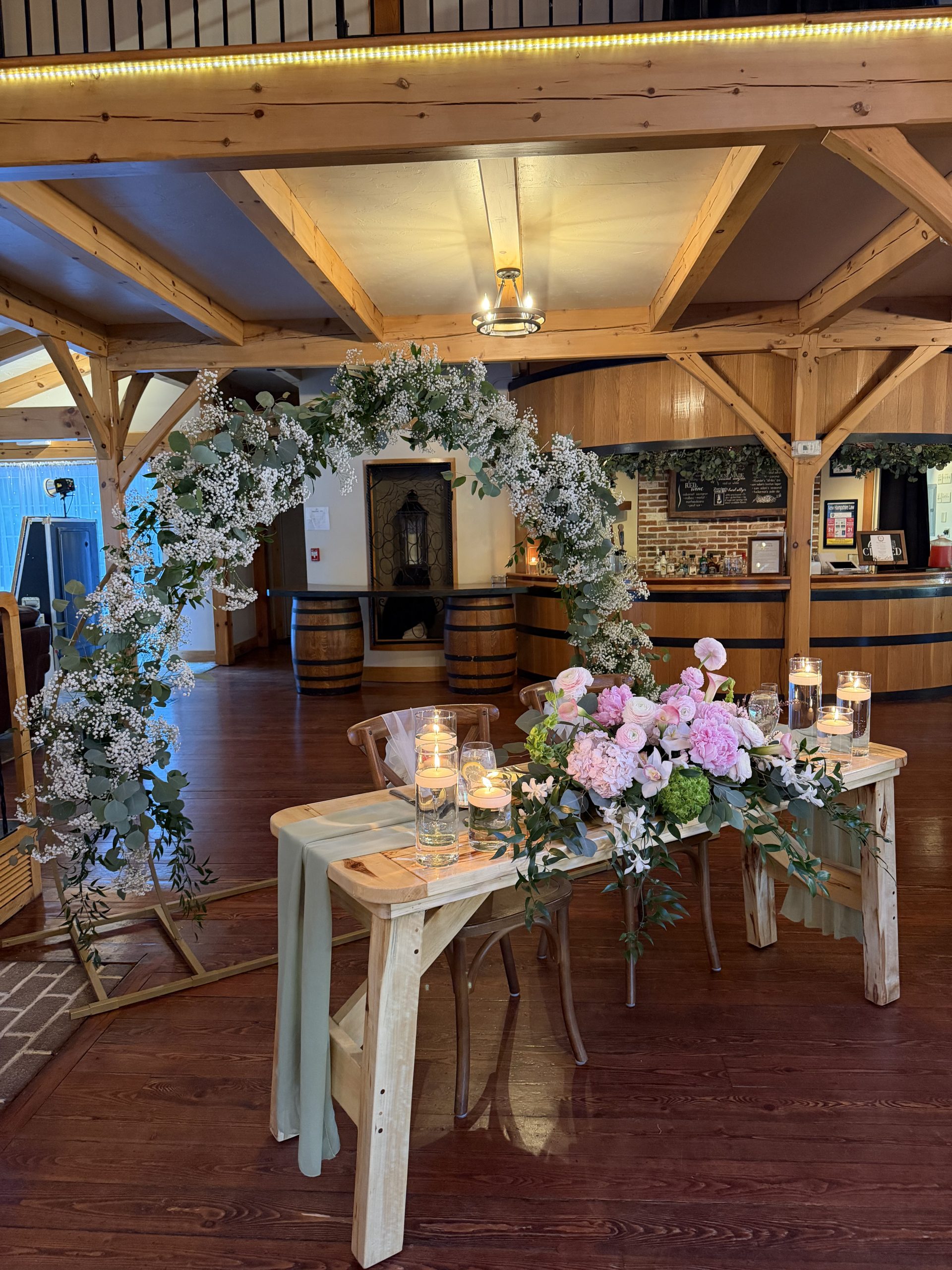 Sweetheart table with baby's breath arch at a vineyard pavilion wedding at Zorvino Vineyards NH